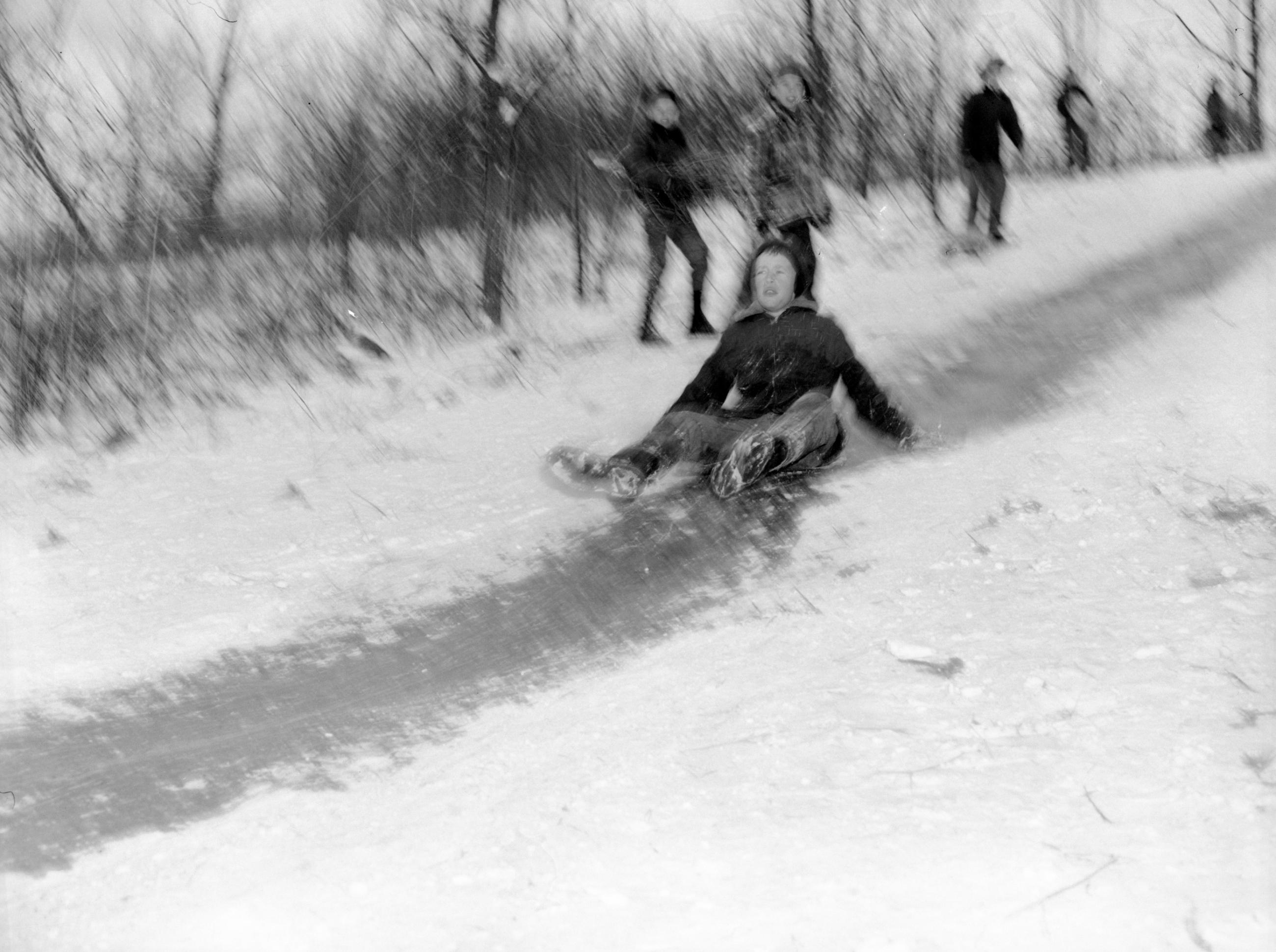 Child Sledding Down "Devil's Hill" Sled Run