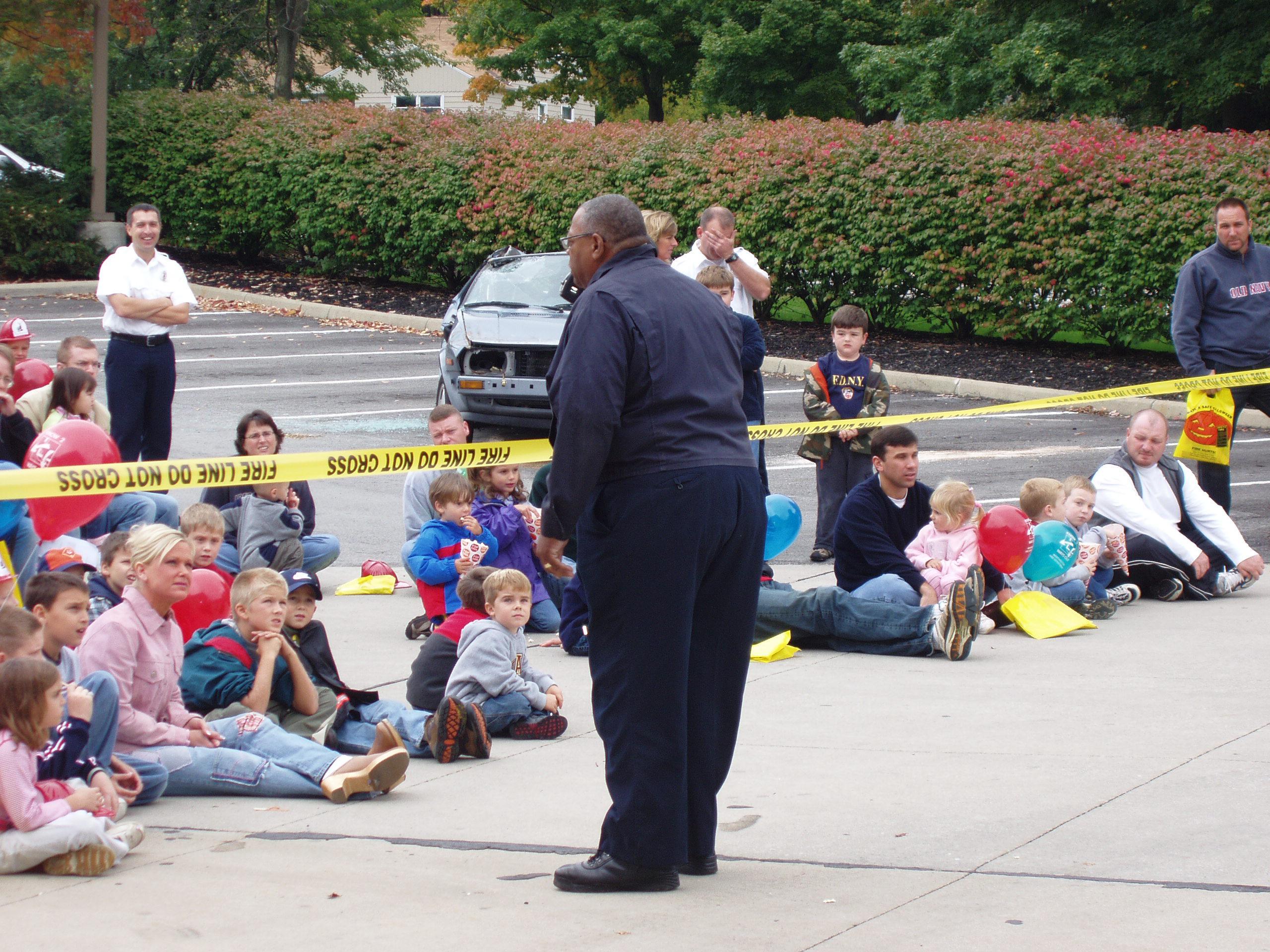 Photograph of Chief William (Bill) Fields, Jr. Speaking to Crowd During Fire Safety Demonstration