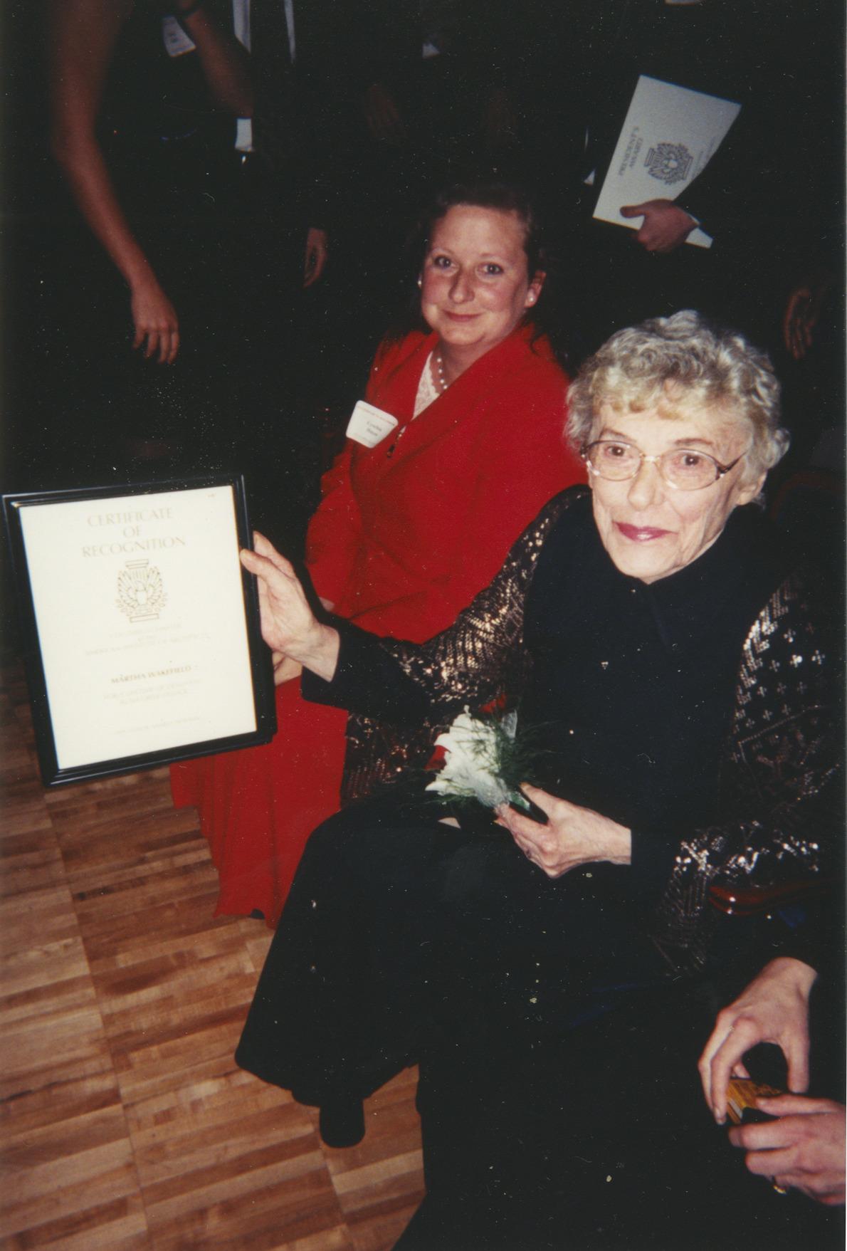 Photograph of Martha Wakefield Holding Certificate of Recognition