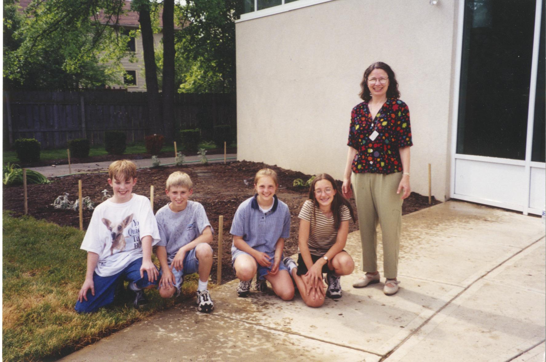Photograph of Rachel Alexander with Children in Storybook Garden at Northwest Library