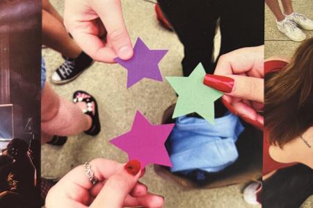 Three hands holding cut out stars