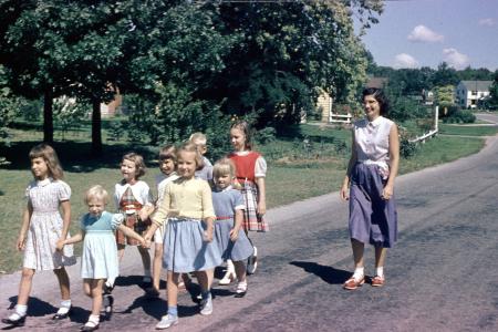 An Adult and Group of Children Walking on Andover Street, 1950s