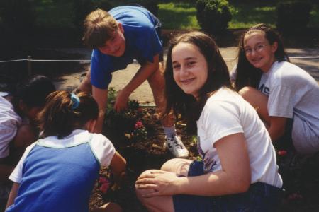 Photograph of Children Smiling While Planting the Storybook Garden at Northwest Library
