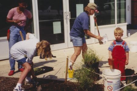 Photograph of Children and Adults Planting Storybook Garden at Northwest Library