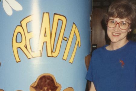 Photograph of Jo Osborne with "Read It" Pillar in Children's Area at the Old Worthington Library