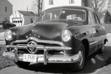 Photograph of Maxine Gail Shirk at Wheel of 1949 Ford Car
