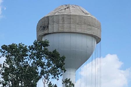 Photograph of Tarp Being Lowered Over Worthington Hills Water Tower Before Repainting, 2020