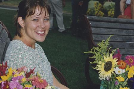 Shopper Sitting on Bench with Flowers at the Worthington Farmer's Market