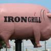Side View of the Pig Sign in Front of Iron Grill Barbeque & Brew